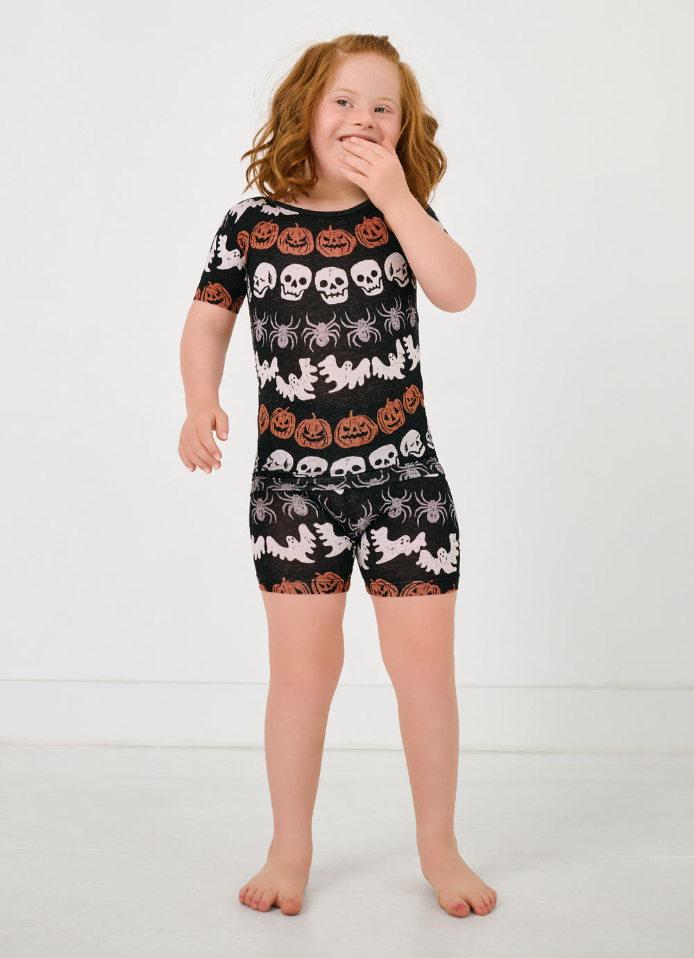 Standing girl wearing the Hallows Eve Two-Piece Short Sleeve & Shorts Pajama Set