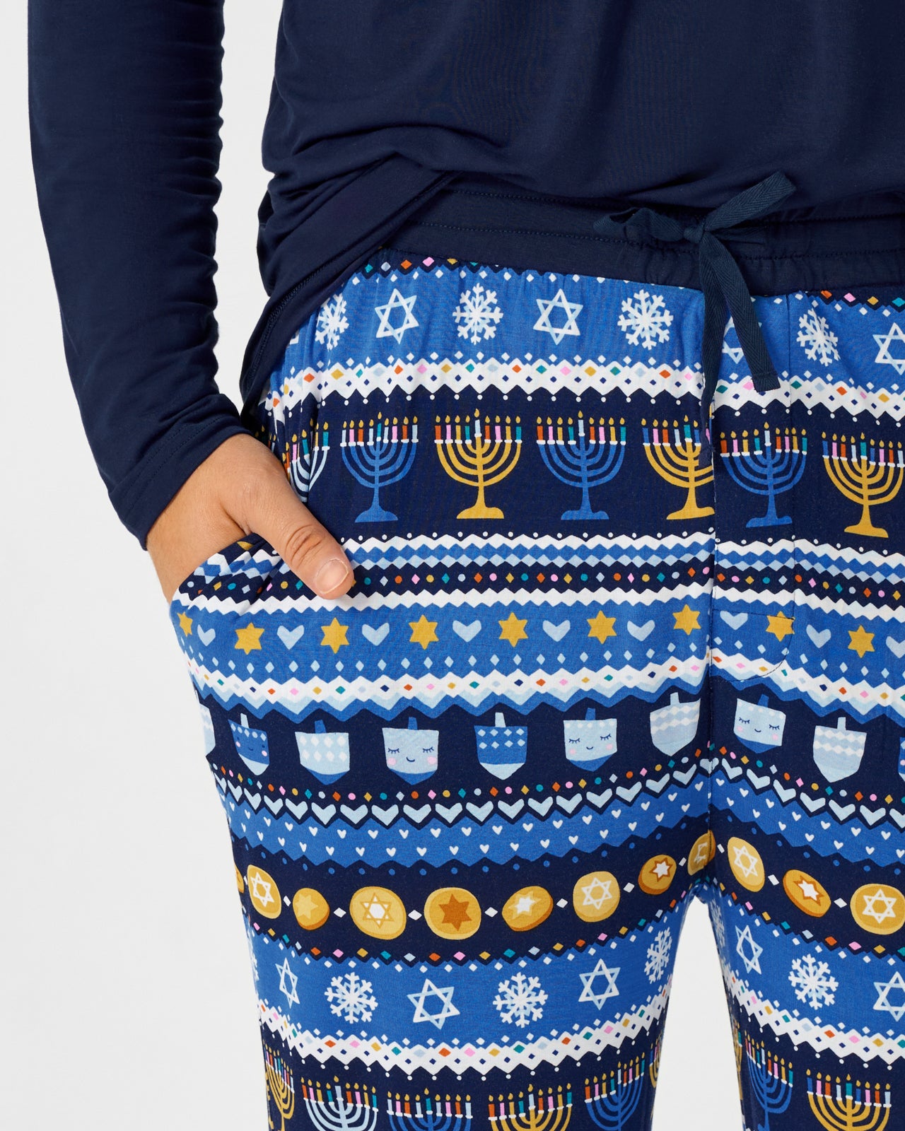 Close up of man wearing the Hanukkah Fair Isle Men's Pajama Pants with a navy top