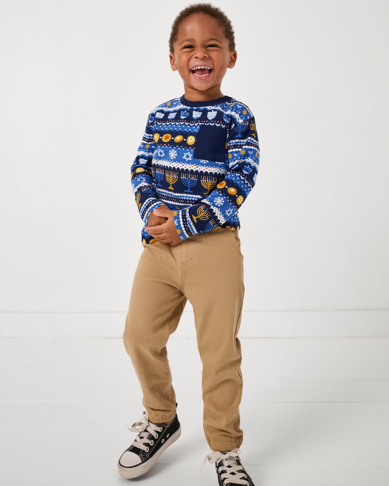 Boy wearing the Hanukkah Fair Isle Relaxed Pocket Tee with khaki joggers