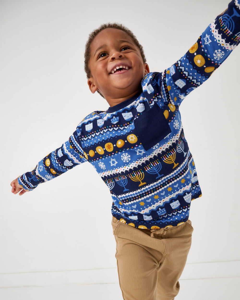 Posing boy wearing the Hanukkah Fair Isle Relaxed Pocket Tee