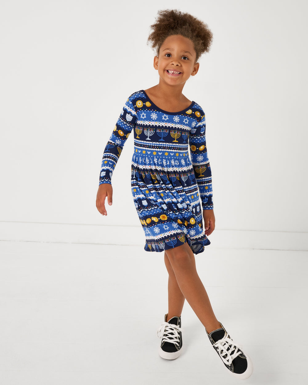 Posing girl wearing the Hanukkah Fair Isle Skater Dress