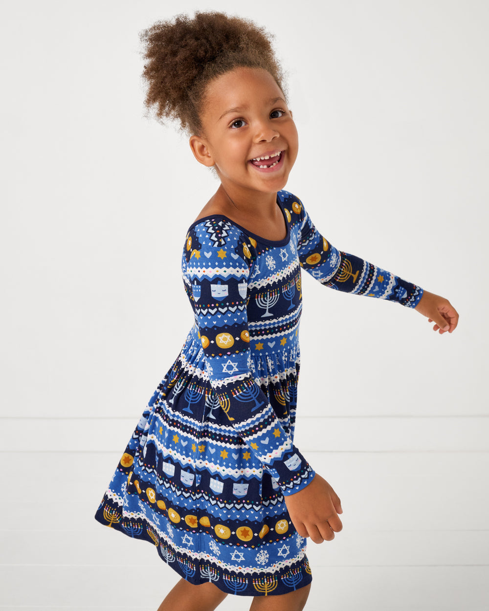 Close up of girl wearing the Hanukkah Fair Isle Skater Dress