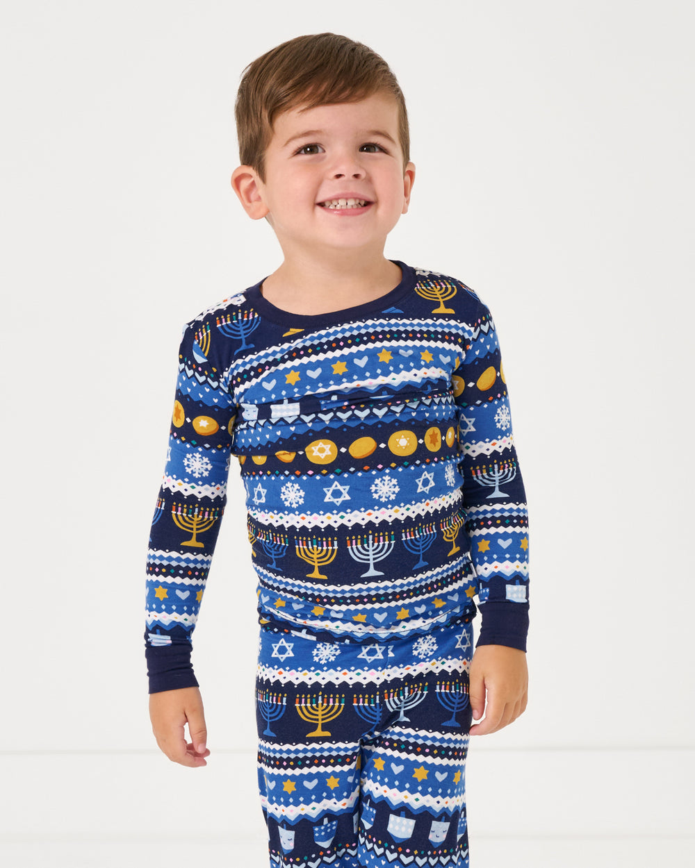 Close up of boy wearing the Hanukkah Fair Isle Two-Piece Pajama Set