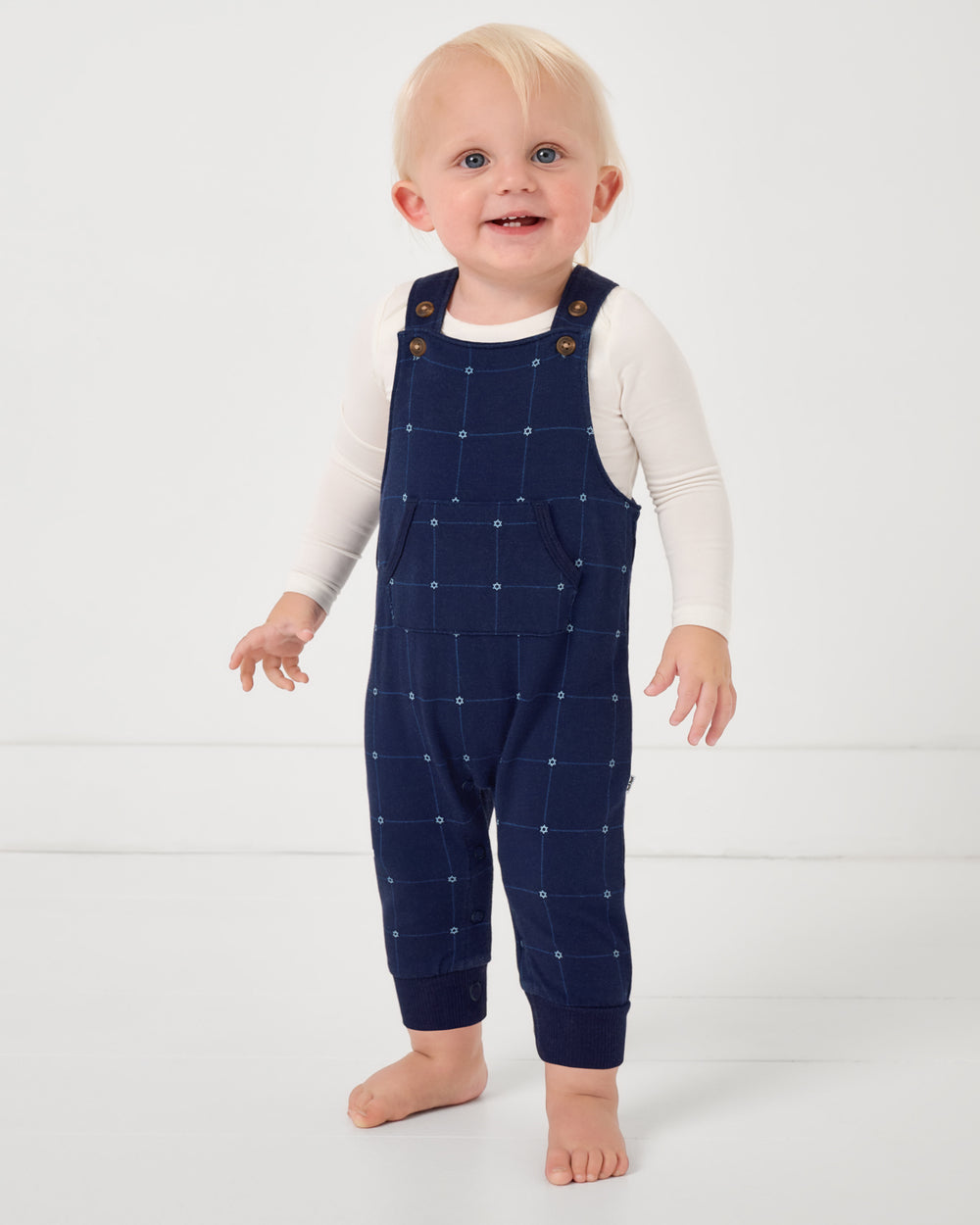 Standing baby wearing the Hanukkah Stars Overall