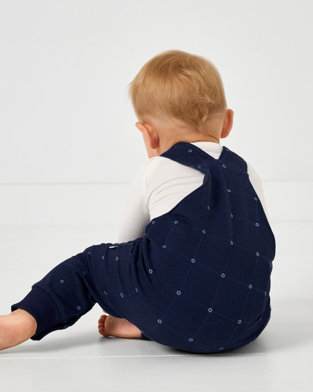 Back view of baby wearing the Hanukkah Stars Overall