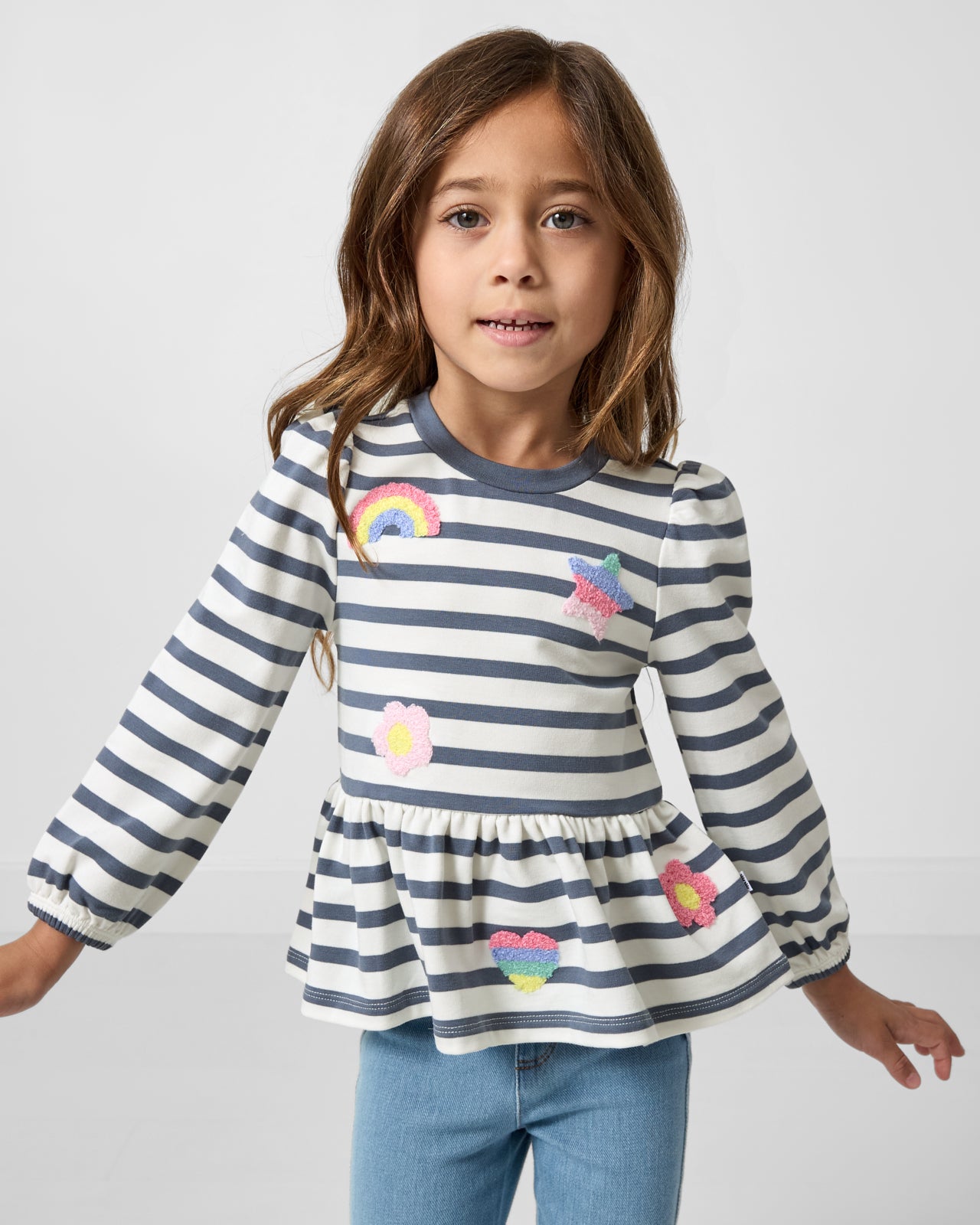 Girl wearing the Hazy Blue Stripe Puff Sleeve Peplum Top