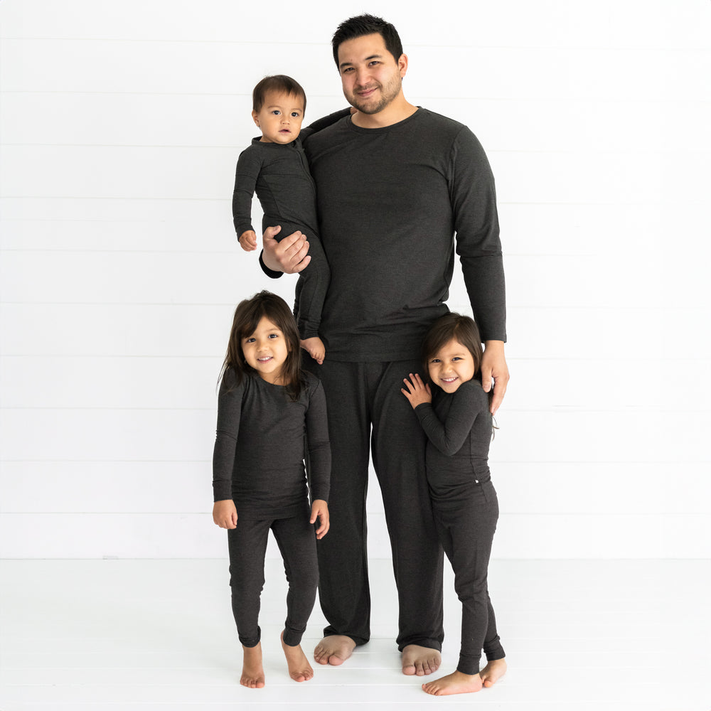 Father and three kids matching wearing Cozy Heather Black pjs sets in mens, and children's two piece and zippy styles.