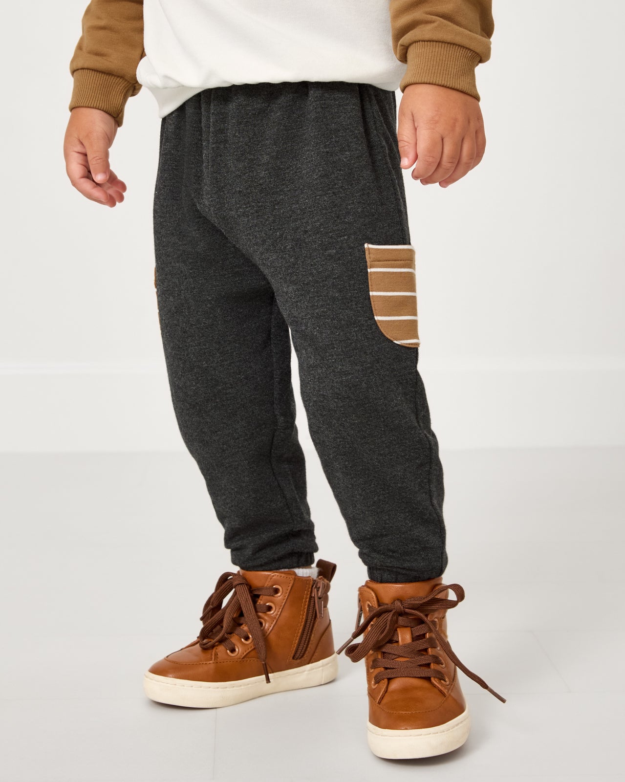 Boy wearing the Heather Black Cinched Jogger with leather sneakers