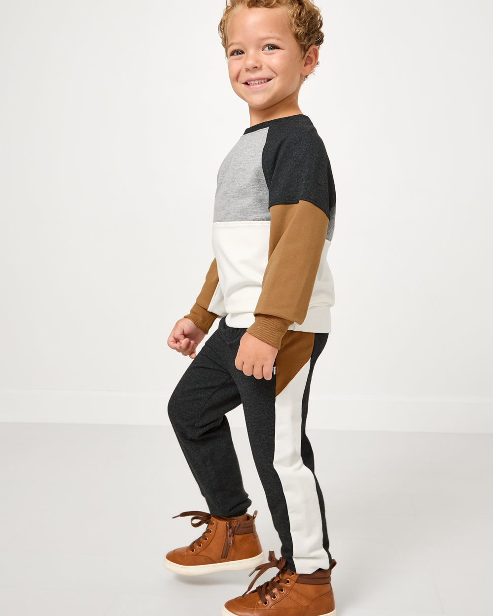 Boy wearing the Heather Black Panel Jogger and matching crewneck