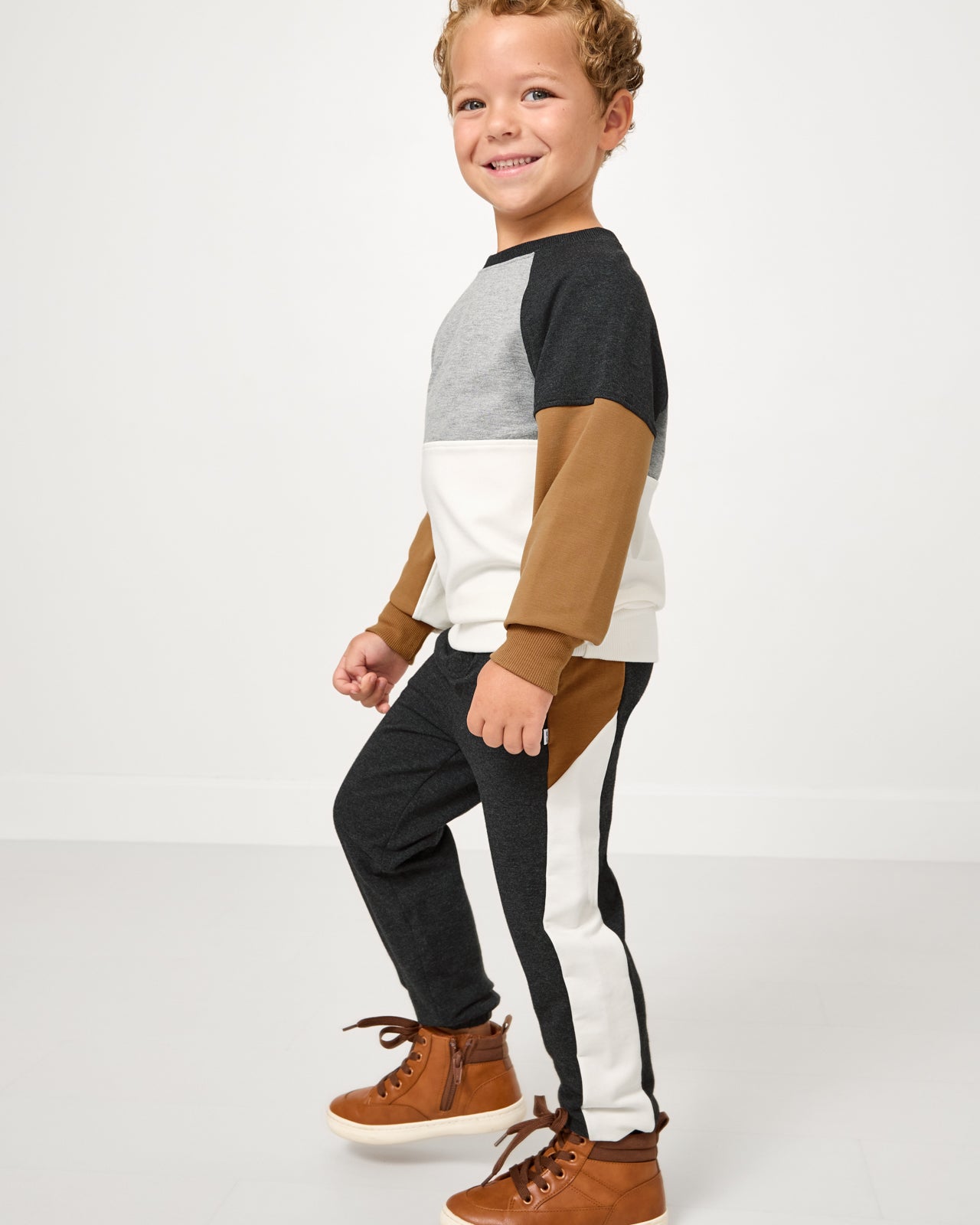 Boy wearing the Heather Black Panel Jogger and matching crewneck