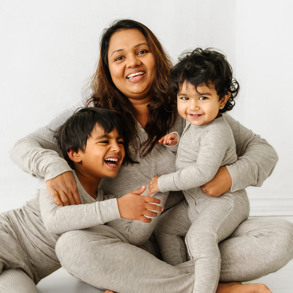 Click to see full screen - Mother and her two children wearing matching Heather Stone Ribbed pajamas. Mom is wearing Women's Heather Stone Ribbed women's pj top and women's pj pants. Her children are matching wearing two piece and zippy styles