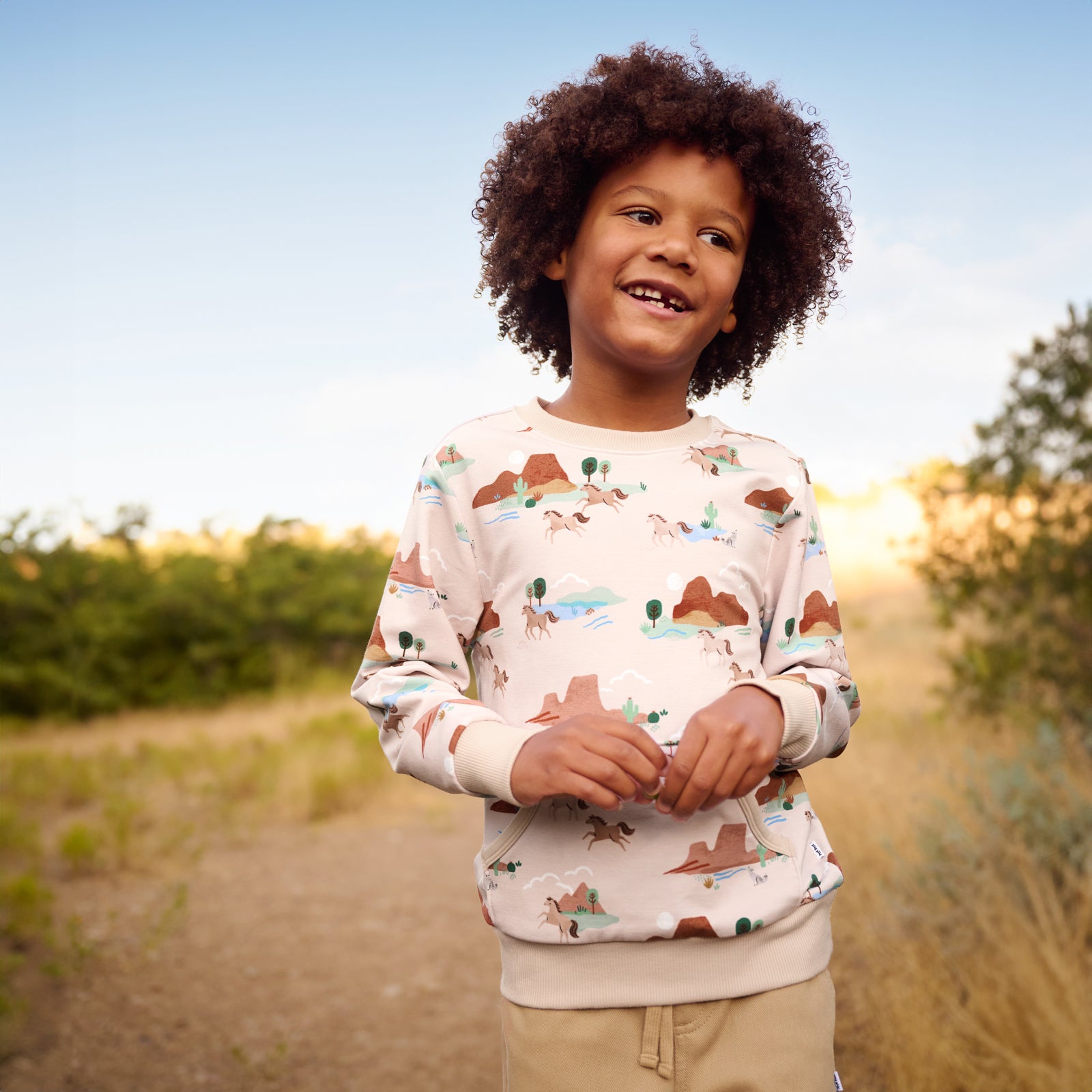 Close up image of boy smiling while wearing the Trail Blazers Pocket Crewneck