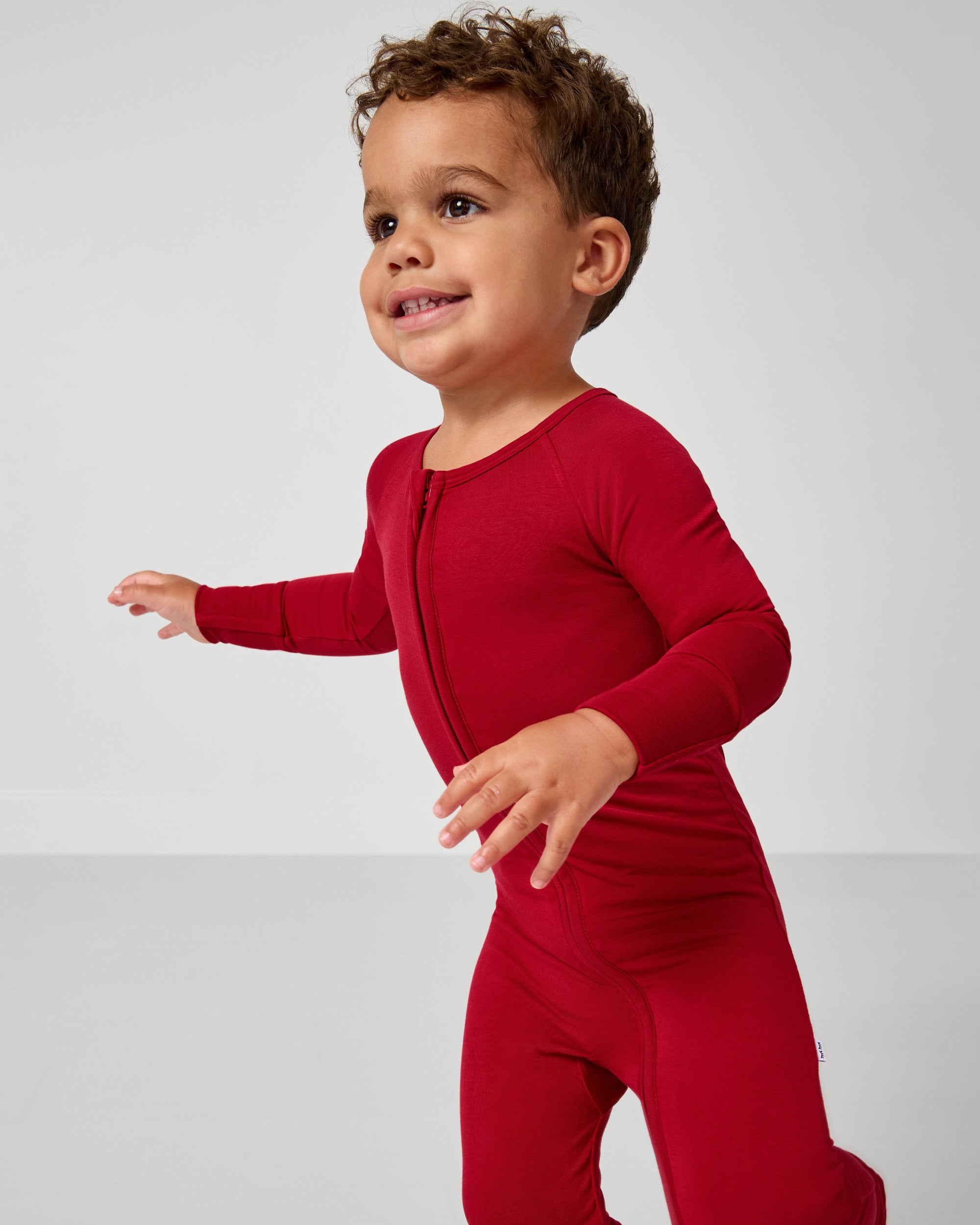 Child in motion wearing the Holiday Red Zippy