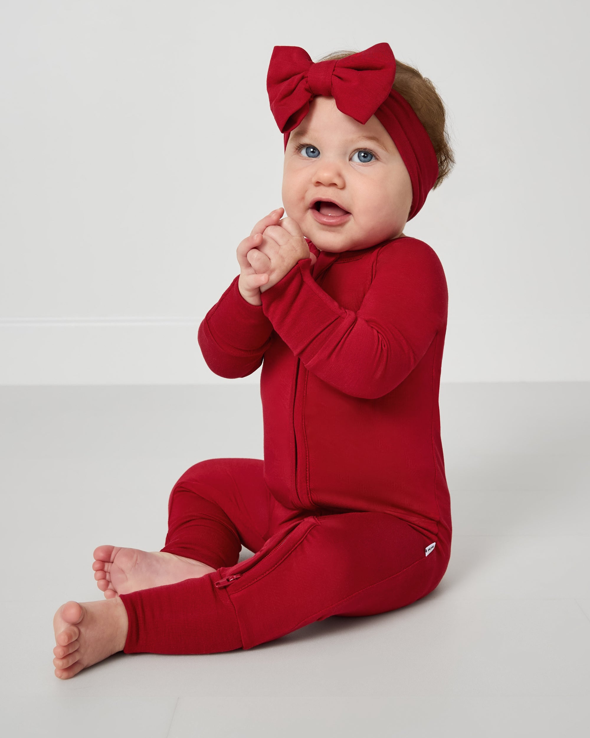 Baby wearing the Holiday Red Zippy
