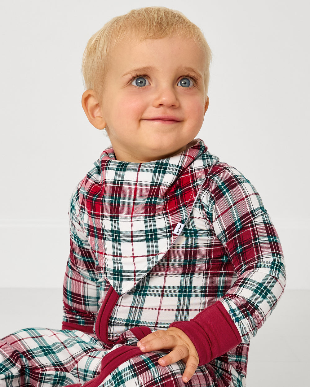 Baby wearing the Holly Plaid Bandana Bib