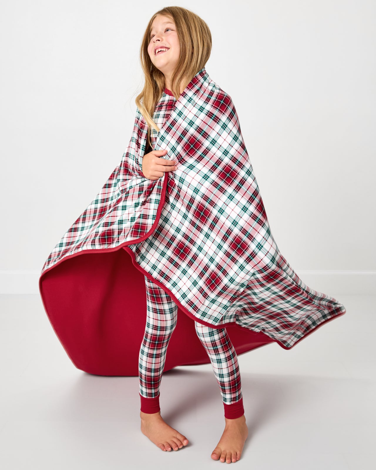 Child wrapped in the Holly Plaid Large Cloud Blanket®