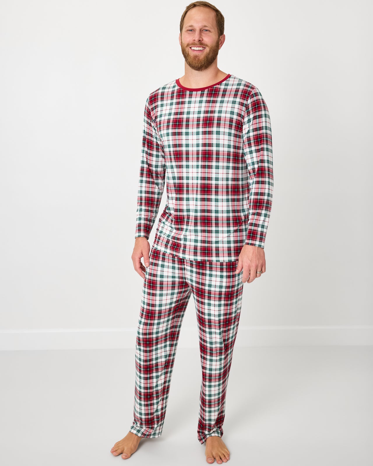 Standing man wearing the Holly Plaid Men's Long Sleeve Pajama Top with matching pajama pants