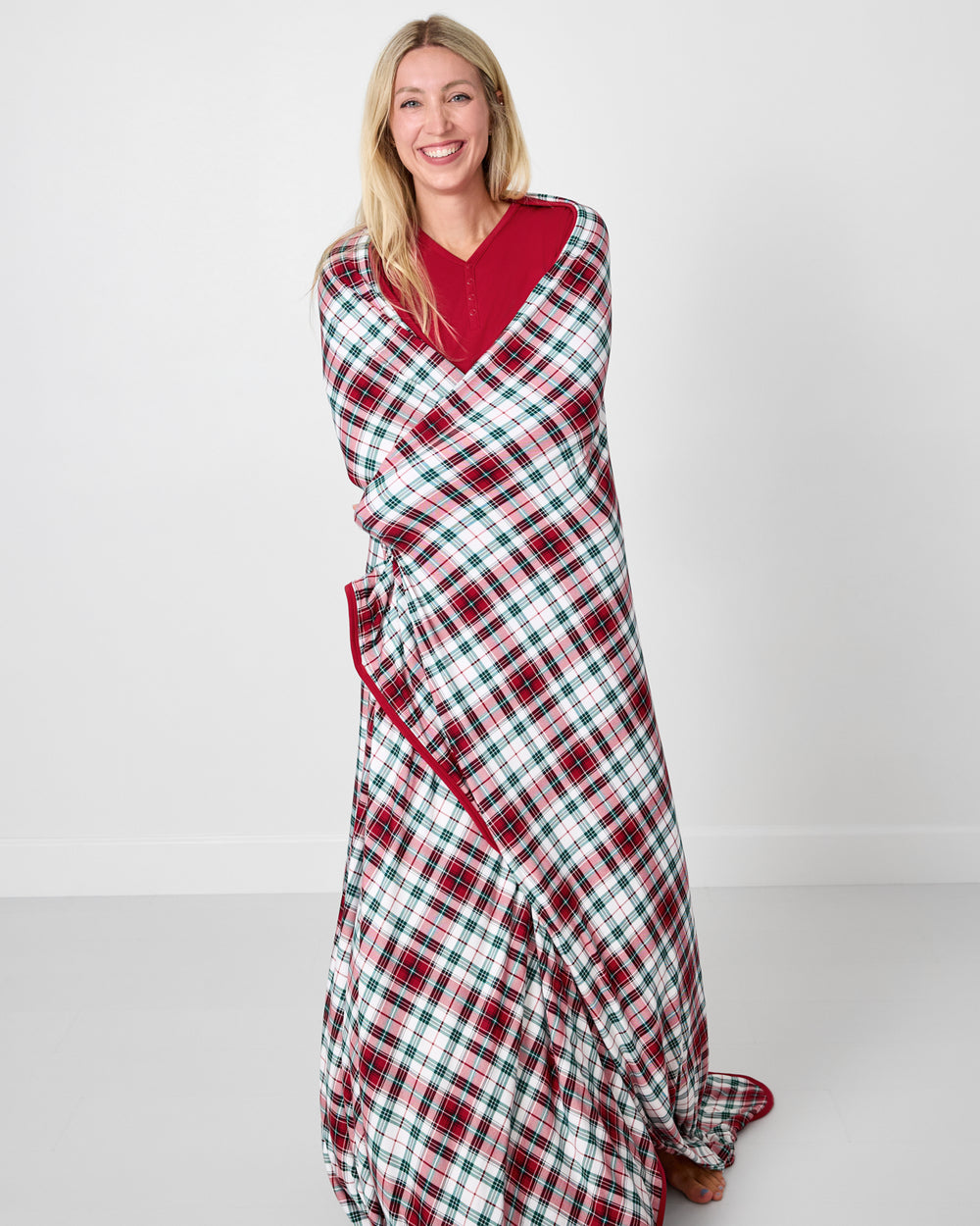 Woman wrapped in the Holly Plaid Oversized Cloud Blanket®