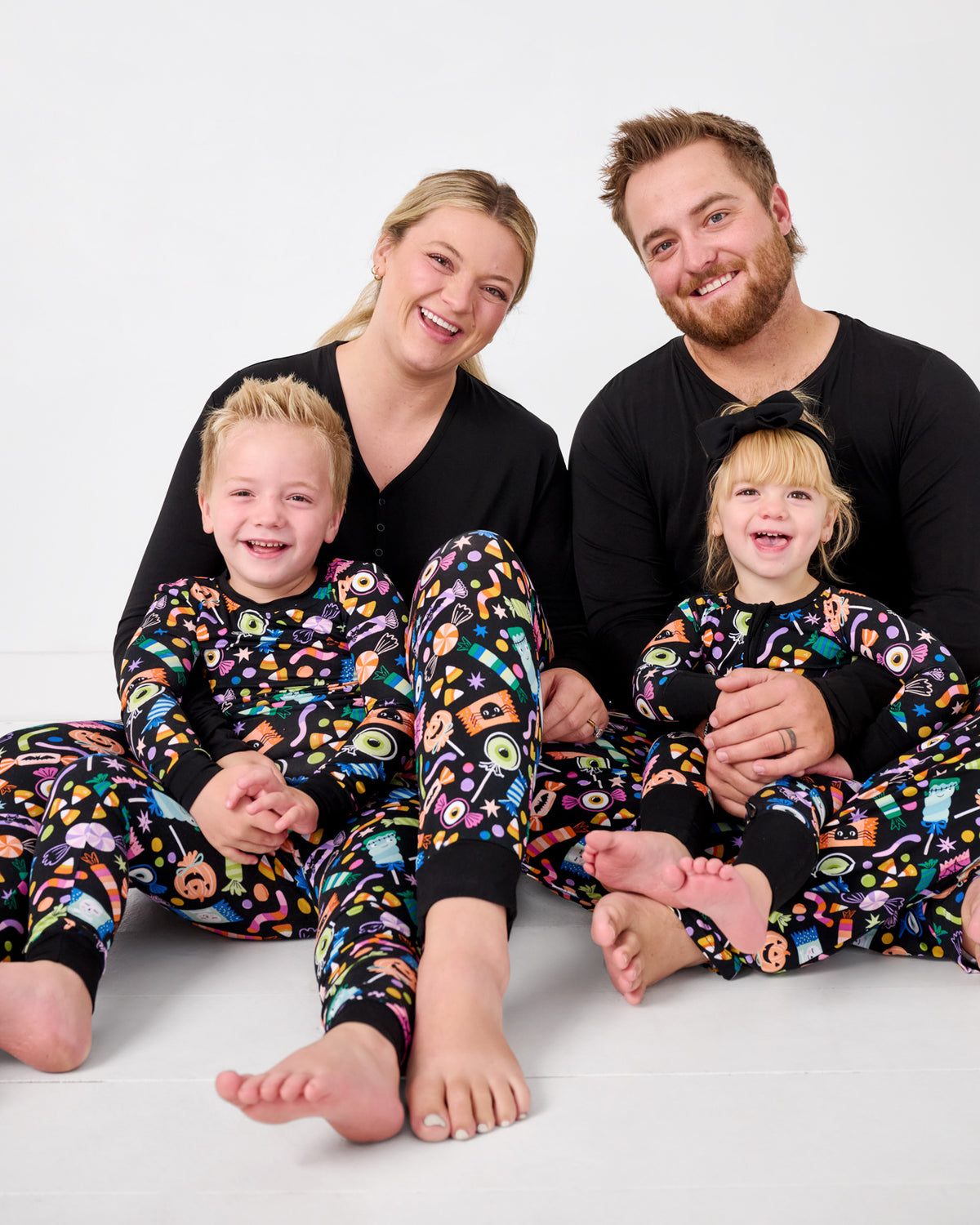 Family of four wearing matching Halloween Haul bamboo pajamas