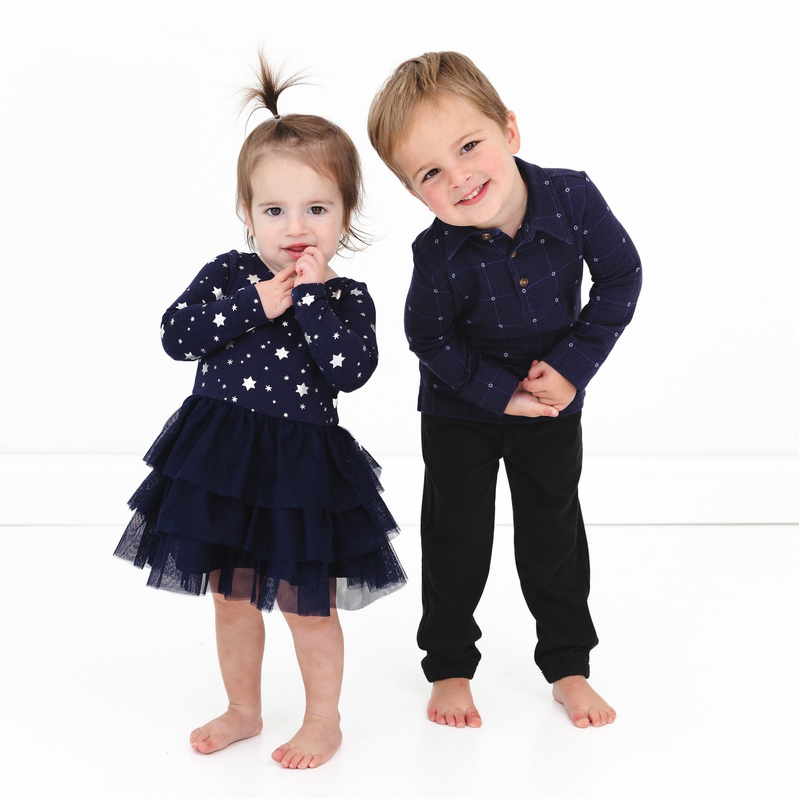 Two children wearing coordinating Hanukkah Stars Play outfits