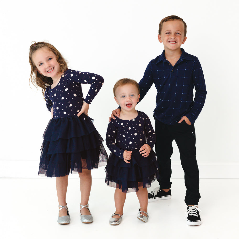 Three children wearing coordinating Hanukkah Stars Play outfits