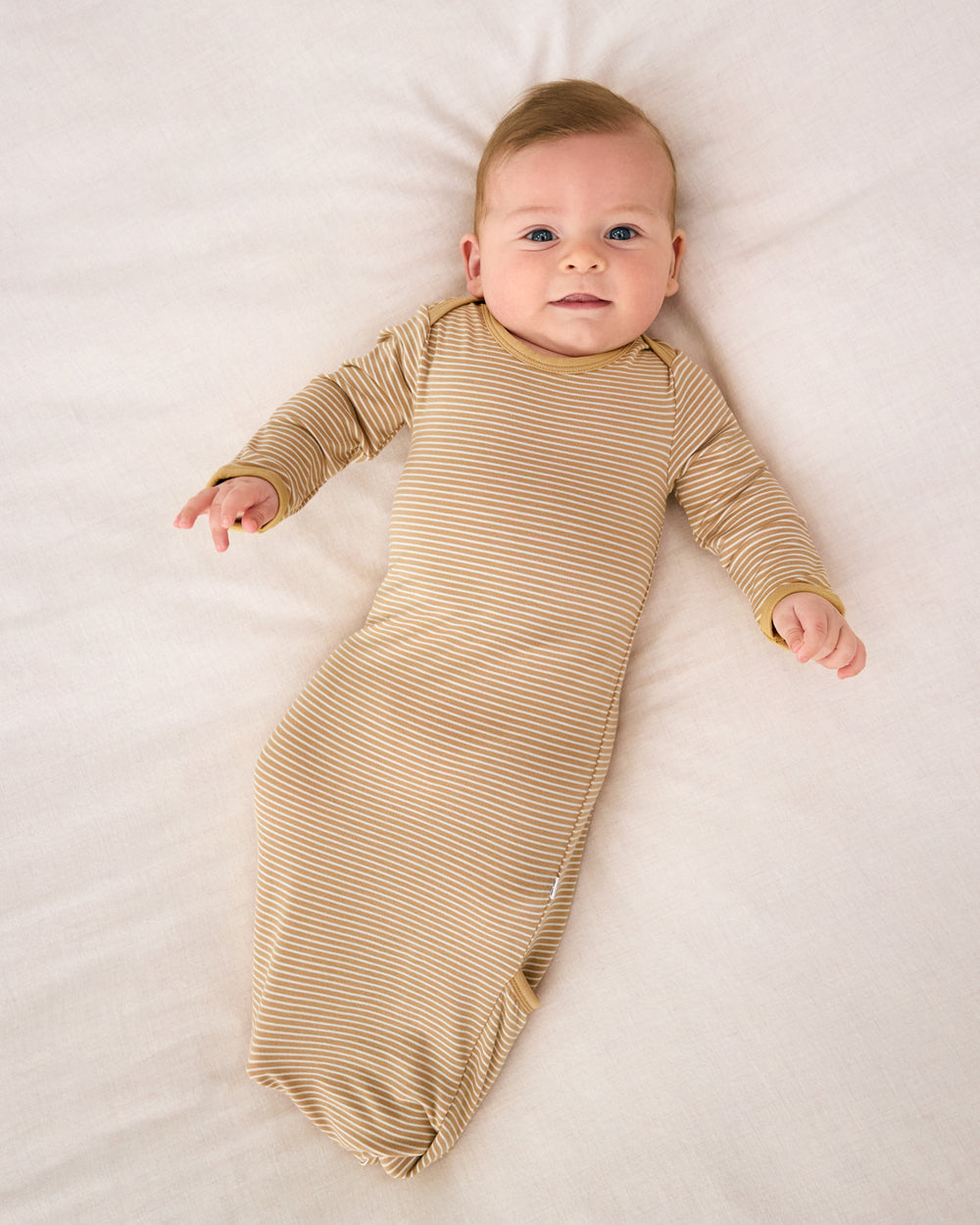 Aerial view of baby wearing the Hazel Wood Stripe Infant Gown