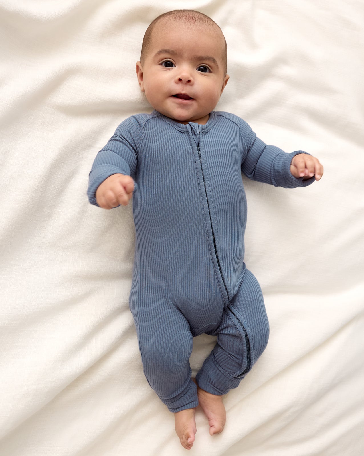 Newborn boy wearing the Hazy Blue Zippy