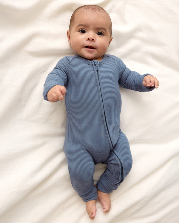Newborn boy wearing the Hazy Blue Zippy