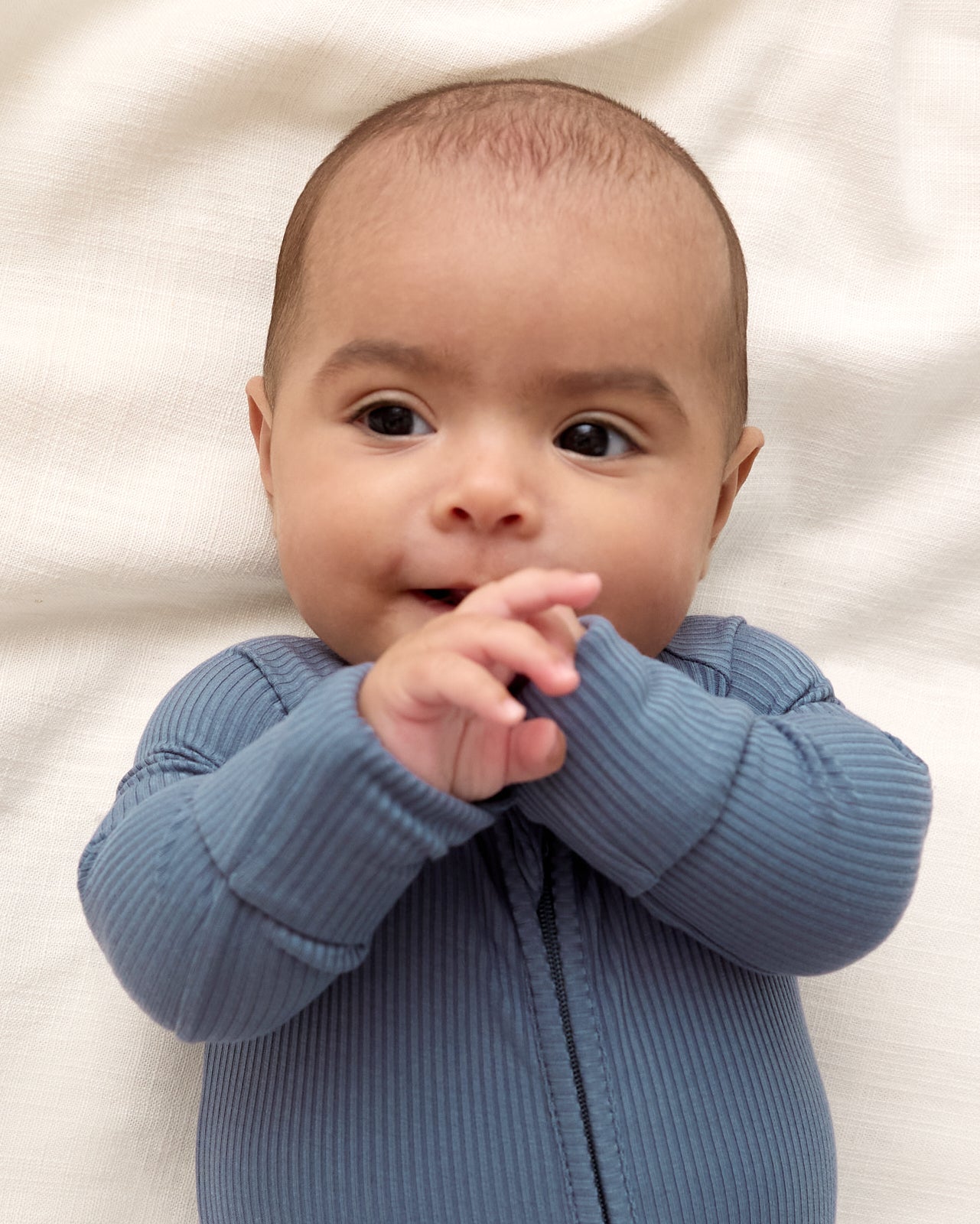 Close up of baby wearing the Hazy Blue Zippy