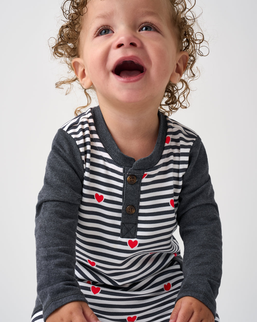 Close up of the henley detail on the Heartstrings Stripe Henley Romper