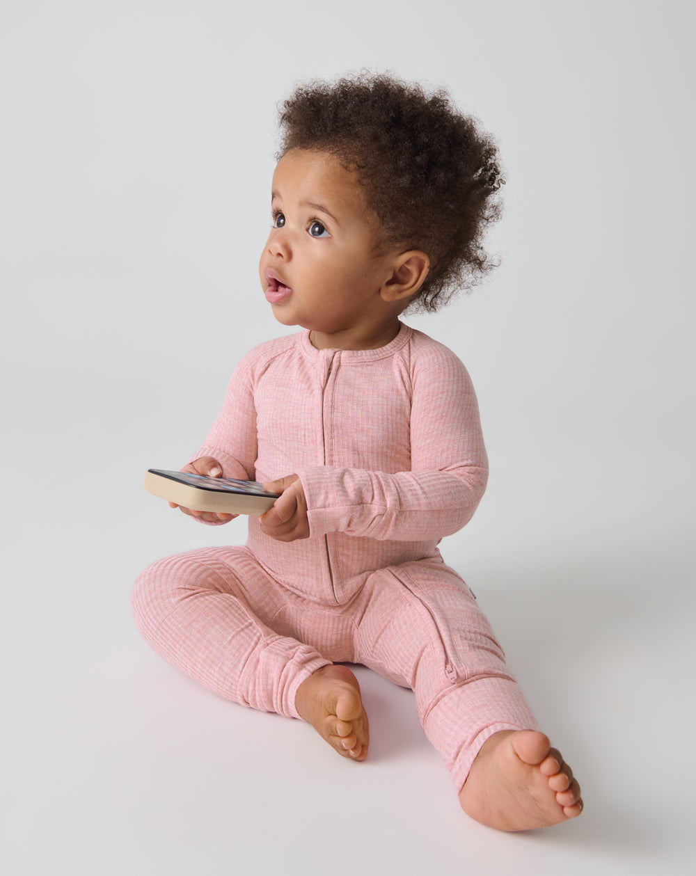 Sitting baby wearing the Heather Mauve Ribbed Zippy