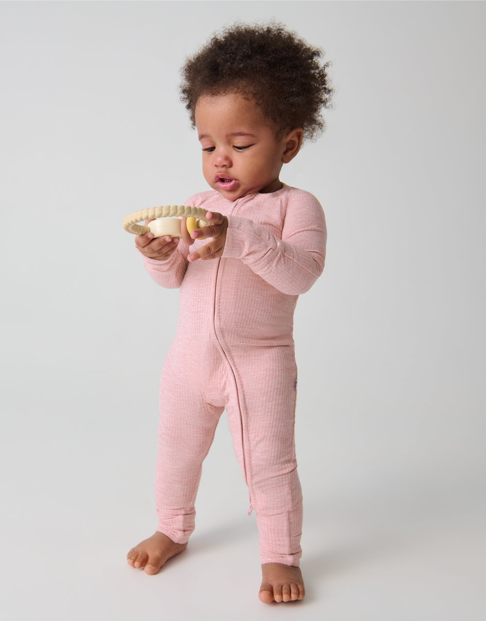 Standing toddler wearing the Heather Mauve Ribbed Zippy