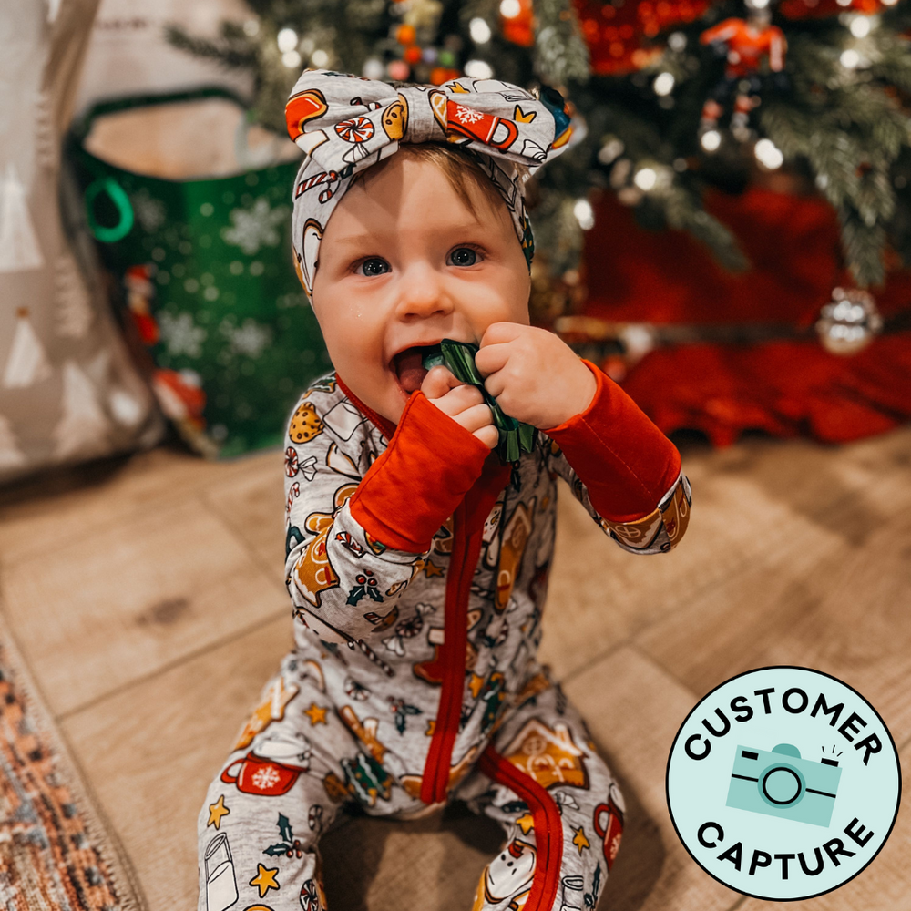 Customer Capture image of a child wearing Holiday Treats luxe bow headband and matching zippy