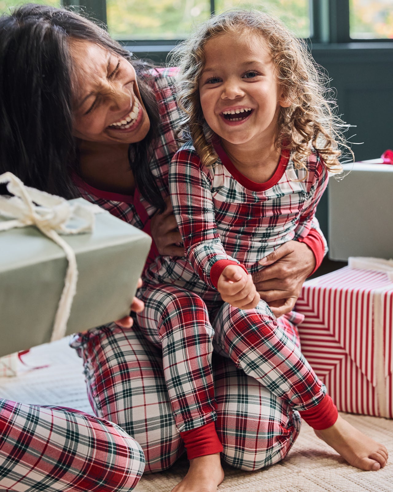 Woman and child wearing matching Holly Plaid pajamas