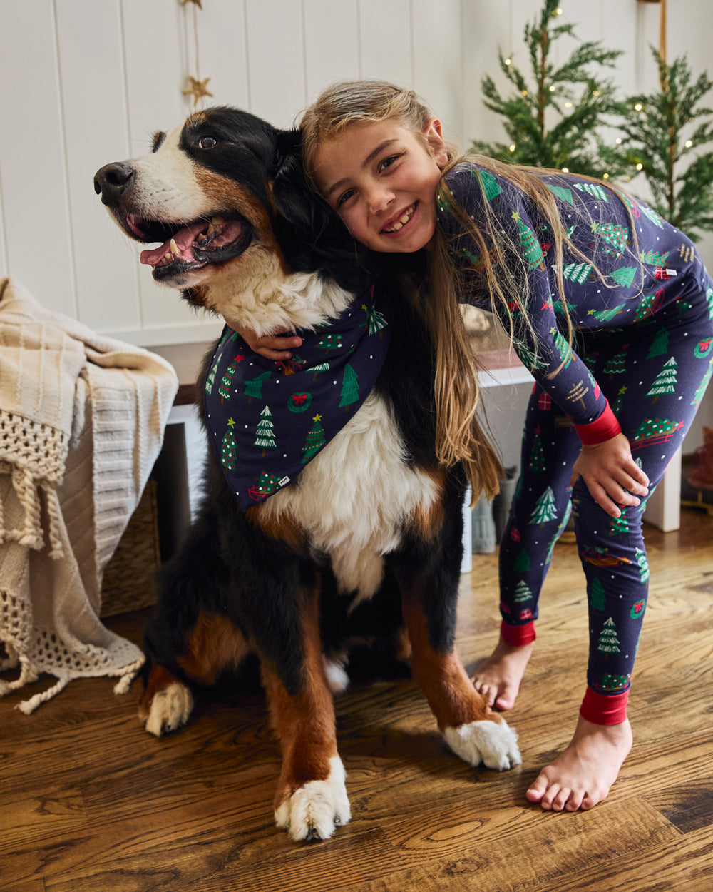 Child hugging dog wearing the Navy Tree Traffic Pet Bandana