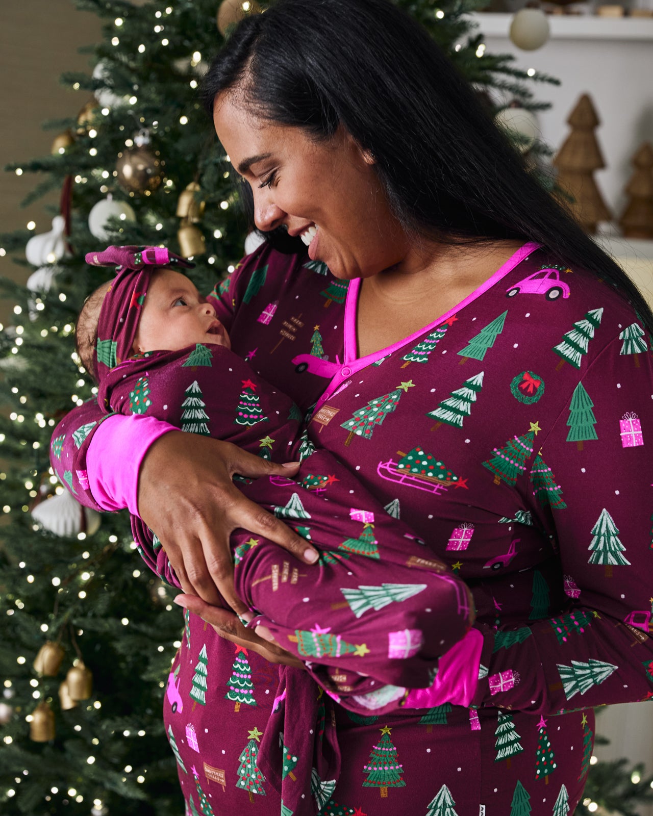 Mother holding baby in the Cranberry Tree Traffic Swaddle & Luxe Bow Headband Set