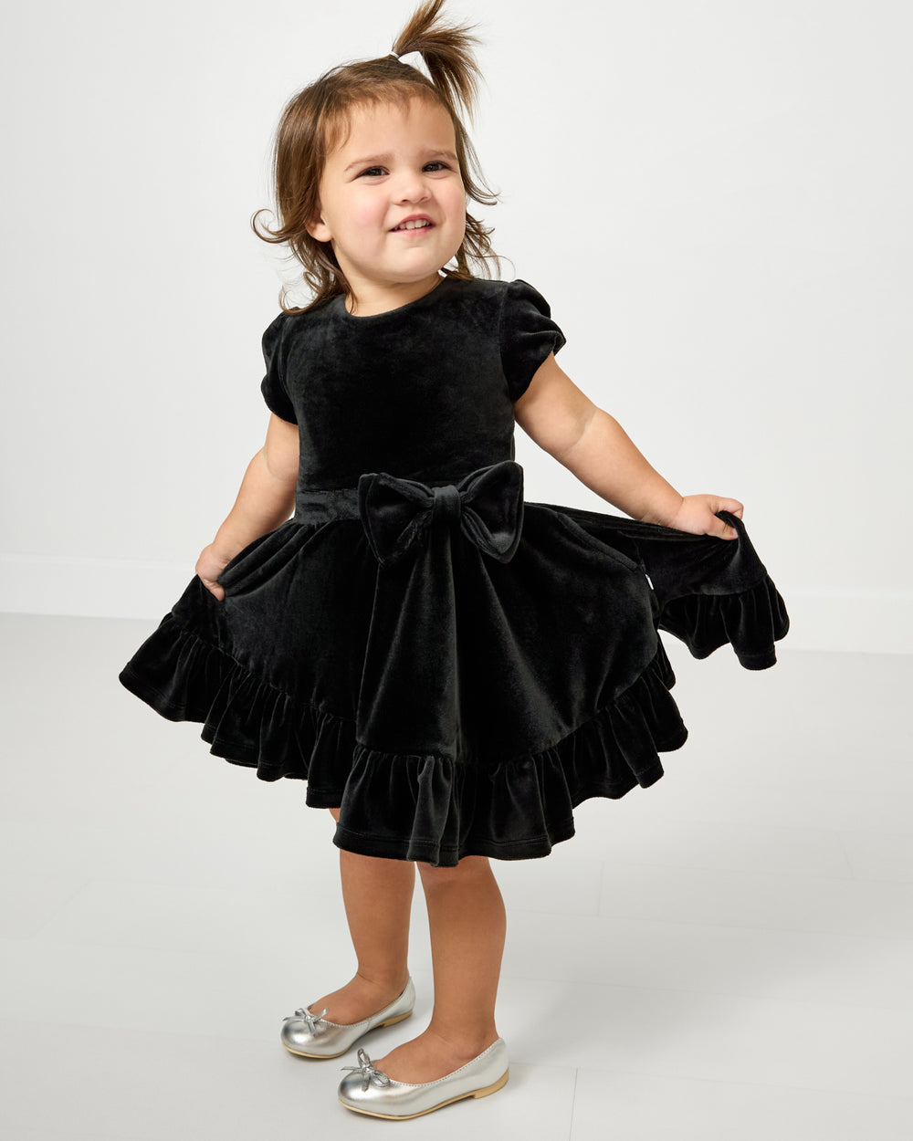 Toddler wearing the Black Velvet Tiered Bow Trim Dress