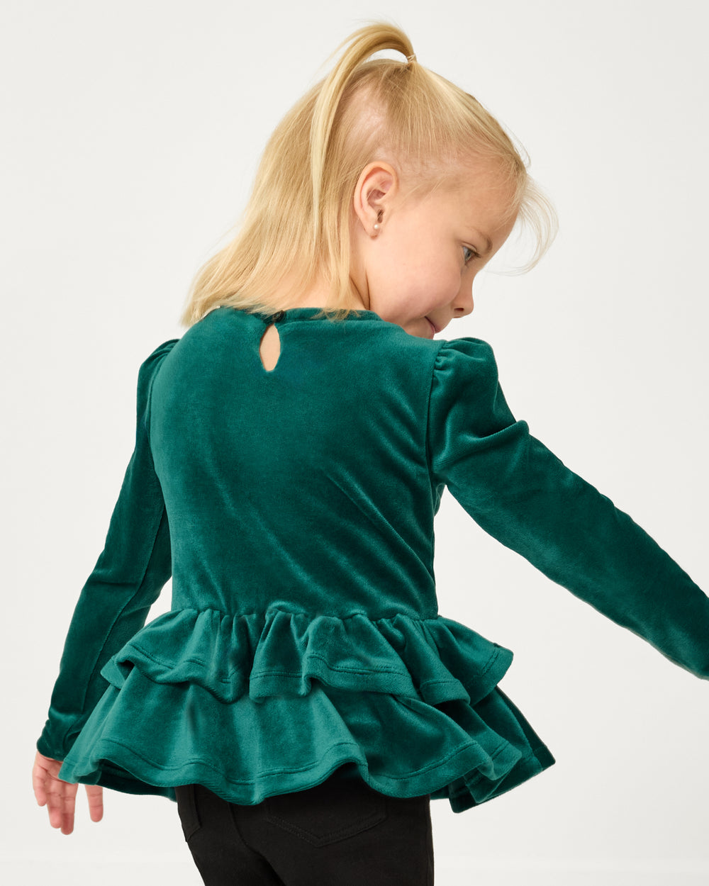 Back view of girl wearing the Emerald Velvet Tiered Peplum Top