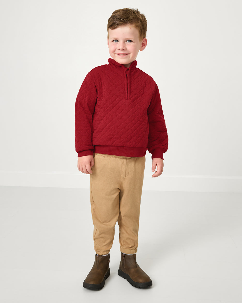 Standing boy wearing the Holiday Red Quilted Zip Pullover with khaki pants