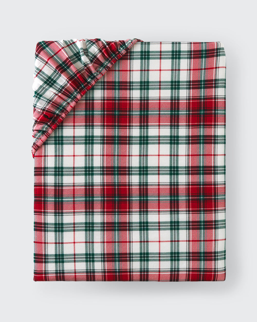 Flat lay of the Holly Plaid Fitted Crib Sheet