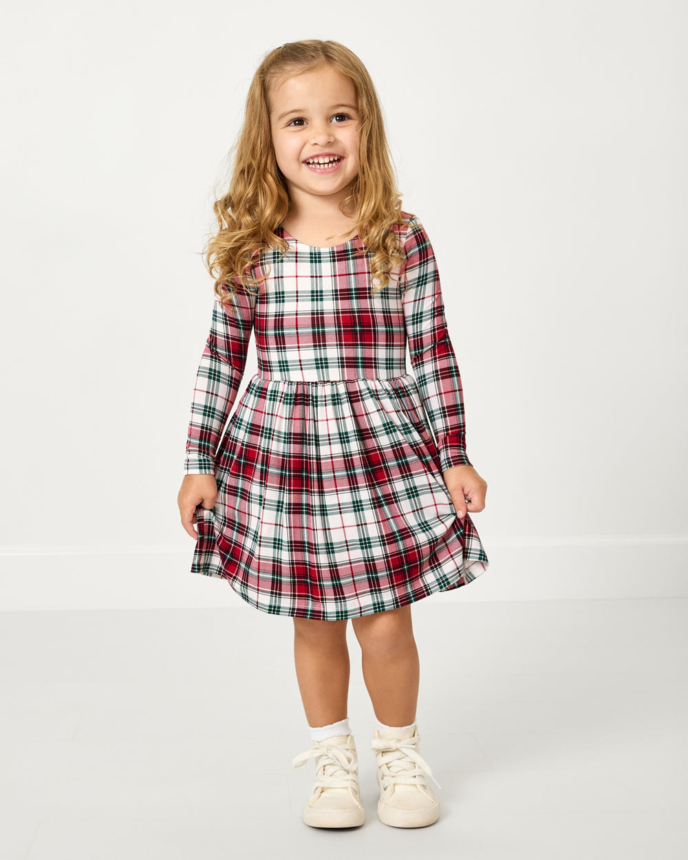 Girl wearing the Holly Plaid Bow Back Skater Dress