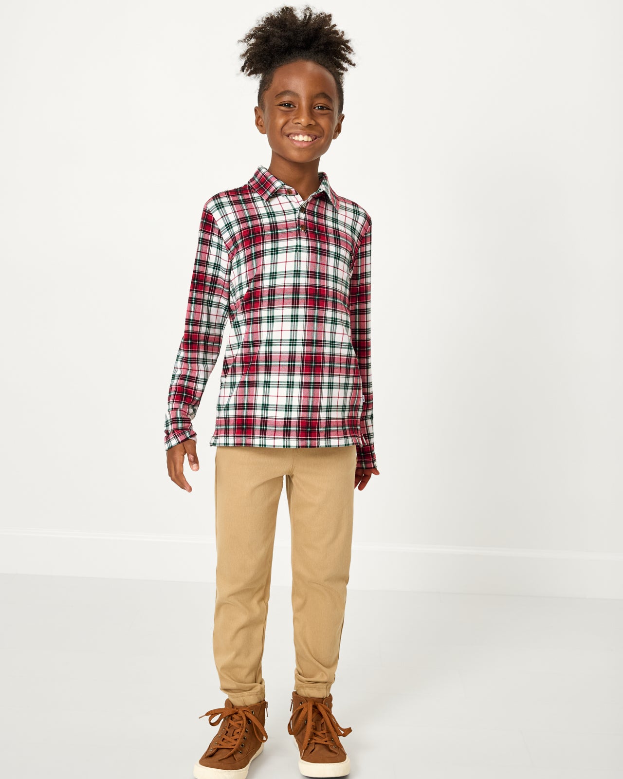 Boy wearing the Holly Plaid Polo Shirt with khaki joggers