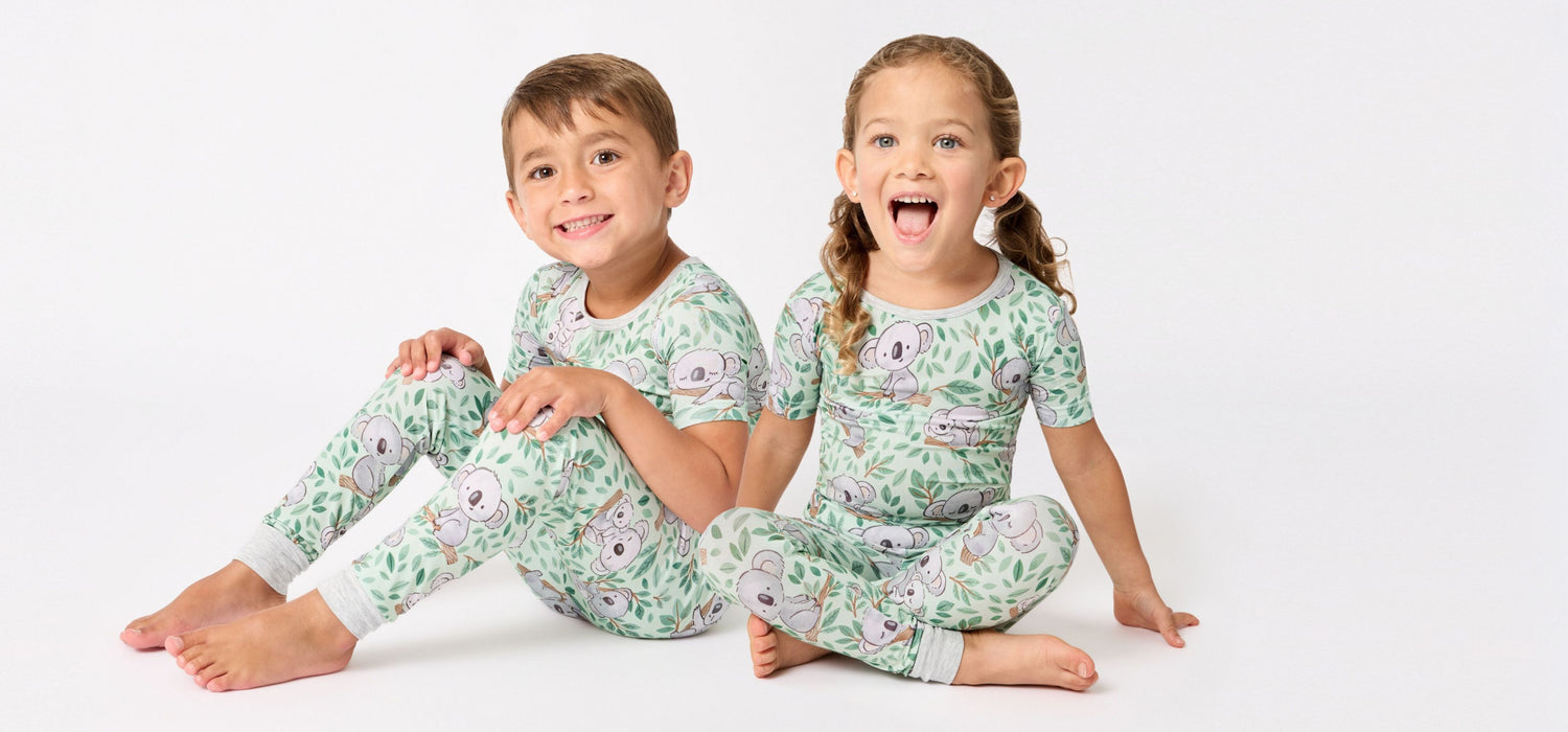Boy and girl siblings wearing Koala Cuddles matching bamboo two-piece pajamas.