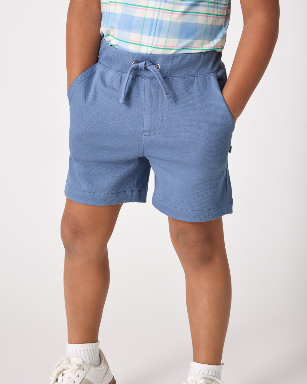 Boy wearing the Infinite Blue Chino Shorts with his hands in the pockets