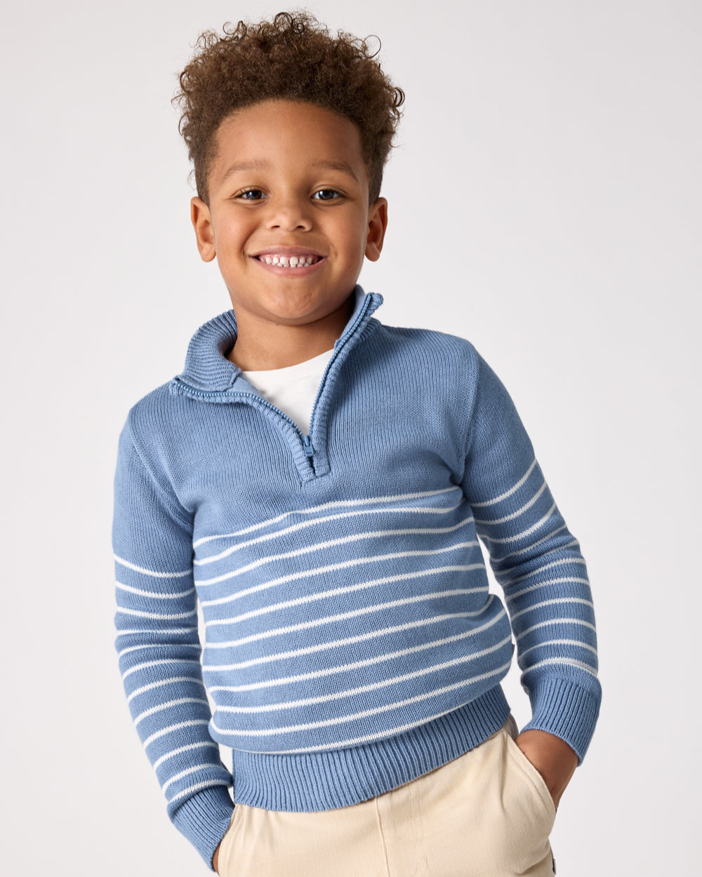 Boy wearing the Infinite Blue Stripe Zip Sweater layered over a white shirt