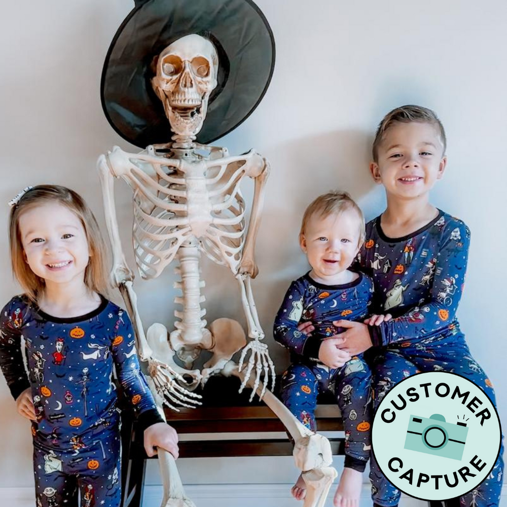 Click to see full screen - Customer Capture image of three children posing together wearing matching Jack Skellington and Friends two piece pajama sets