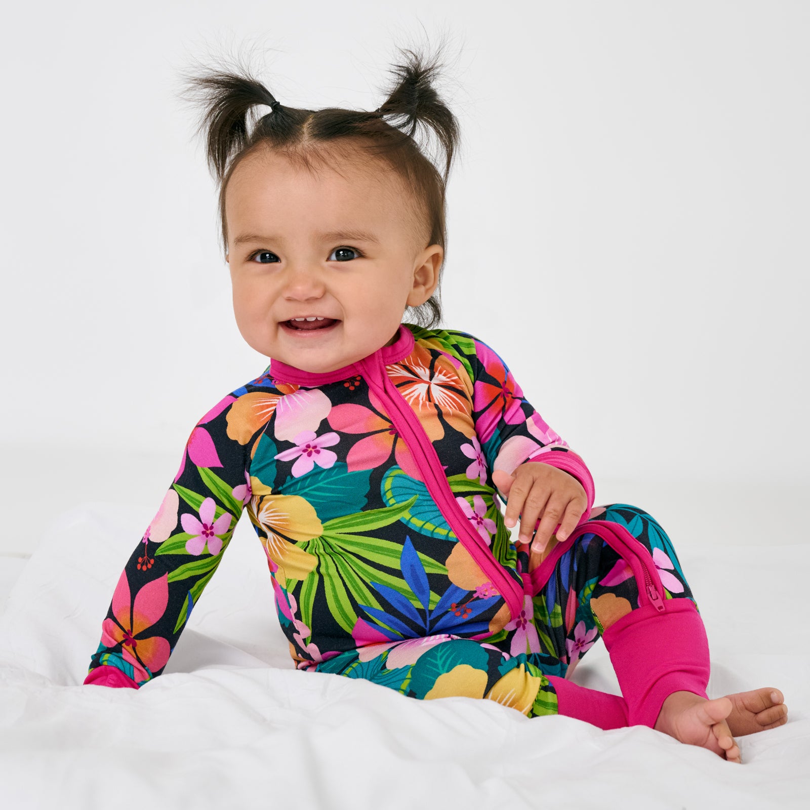 Sitting child wearing the Jungle Blooms Zippy