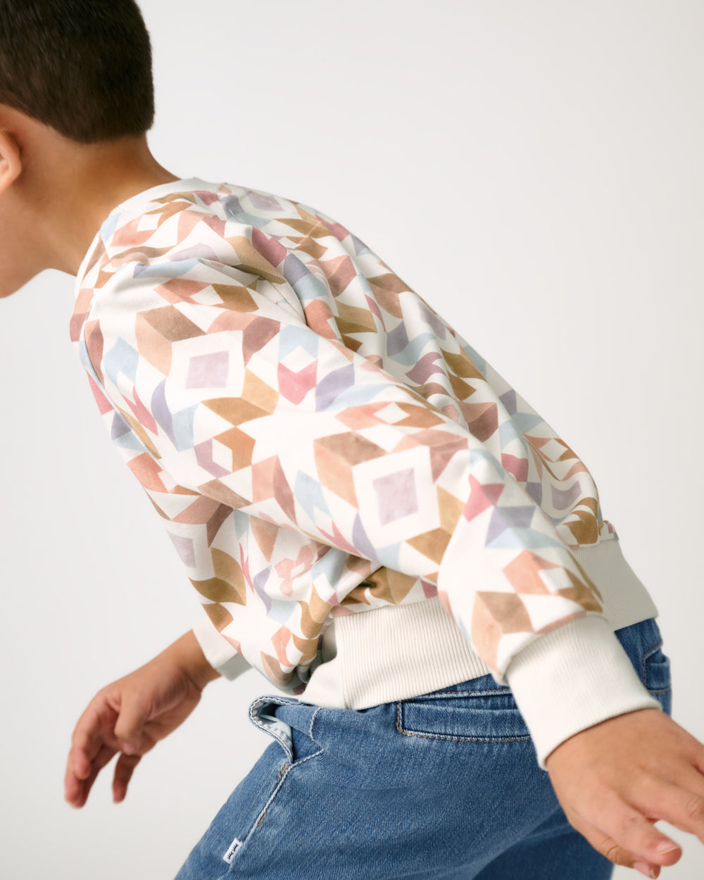 Boy in motion wearing the Kaleidoscope Dreams Crewneck Sweatshirt