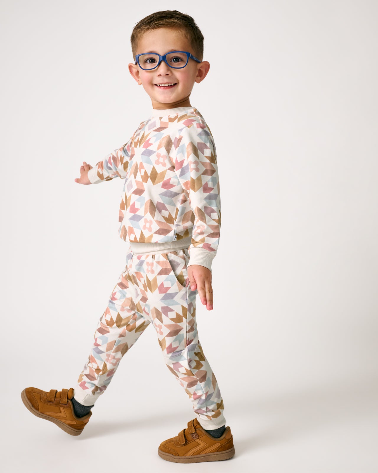 Walking boy wearing the Kaleidoscope Dreams Jogger and Crewneck