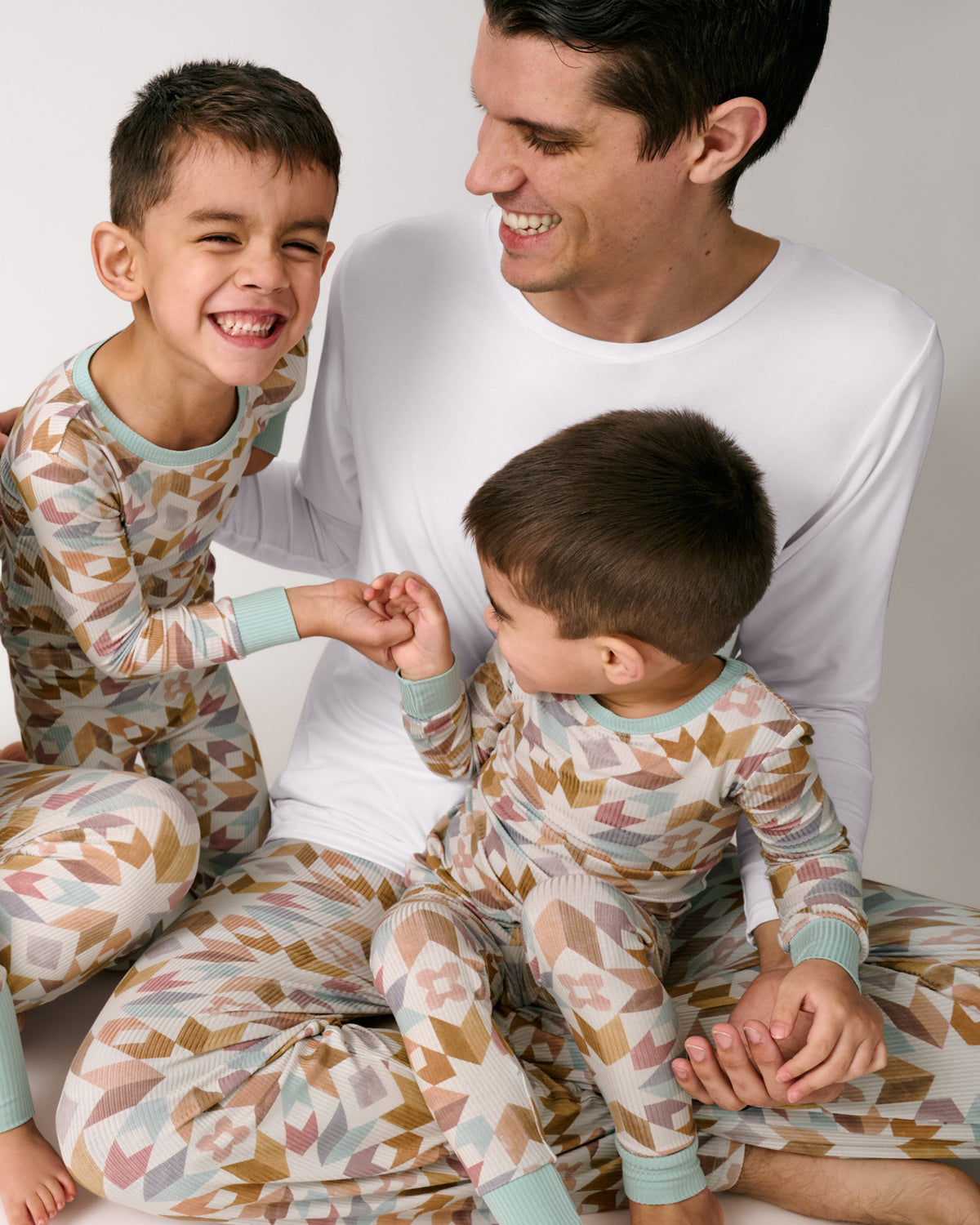 Father and two children wearing matching Kaleidoscope Dreams Ribbed Pajamas